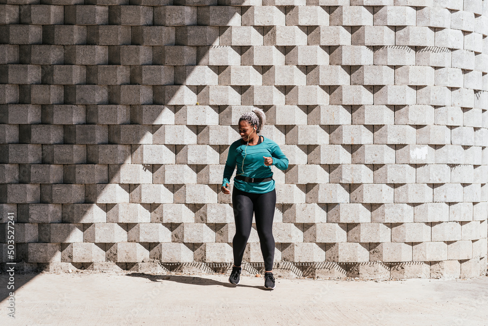 African American woman outdoors doing a cardio routine. African American woman outdoors doing a cardio routine.