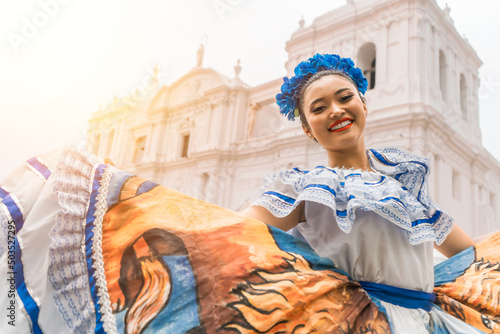 Murais de parede Nicaraguan folklore dancer smiling and looking at the camera outside the cathedral church in the central park of the city of Leon