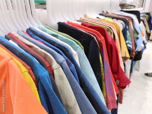 colorful men t shirts on hangers