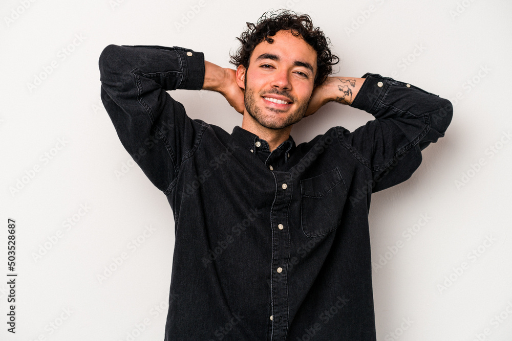 Young caucasian man isolated on white background stretching arms, relaxed position.