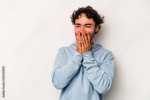 Young caucasian man isolated on white background laughing about something  covering mouth with hands.