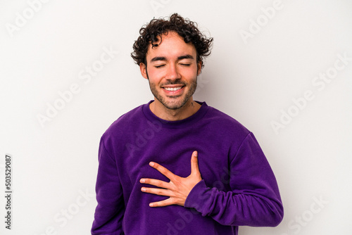 Wallpaper Mural Young caucasian man isolated on white background laughs out loudly keeping hand on chest. Torontodigital.ca