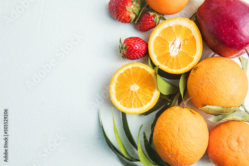 Fruit sources of vitamins  background fruits Fresh . Assorted fruits colorful  clean eating  Top view.Summer tropical vitamin drinks fruits and juices on wooden table Detox diet and weight loss concep