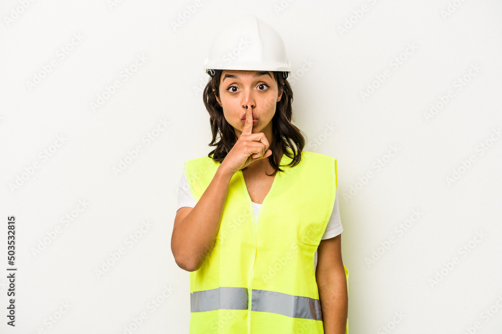Young laborer hispanic woman isolated on white background keeping a secret or asking for silence. Young laborer hispanic woman isolated on white background keeping a secret or asking for silence.