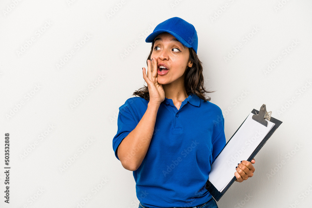 Young hispanic woman delivery man isolated on white background is saying a secret hot braking news and looking aside Young hispanic woman delivery man isolated on white background is saying a secret hot braking news and looking aside