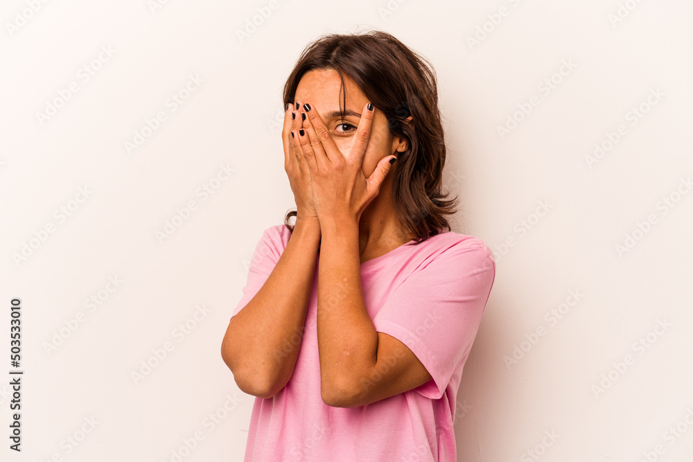 Young hispanic woman isolated on white background blink through fingers frightened and nervous. Young hispanic woman isolated on white background blink through fingers frightened and nervous.