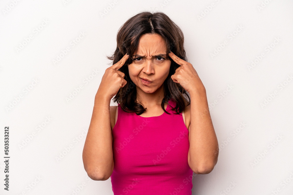 Young hispanic woman isolated on white background focused on a task, keeping forefingers pointing head. Young hispanic woman isolated on white background focused on a task, keeping forefingers pointing head.
