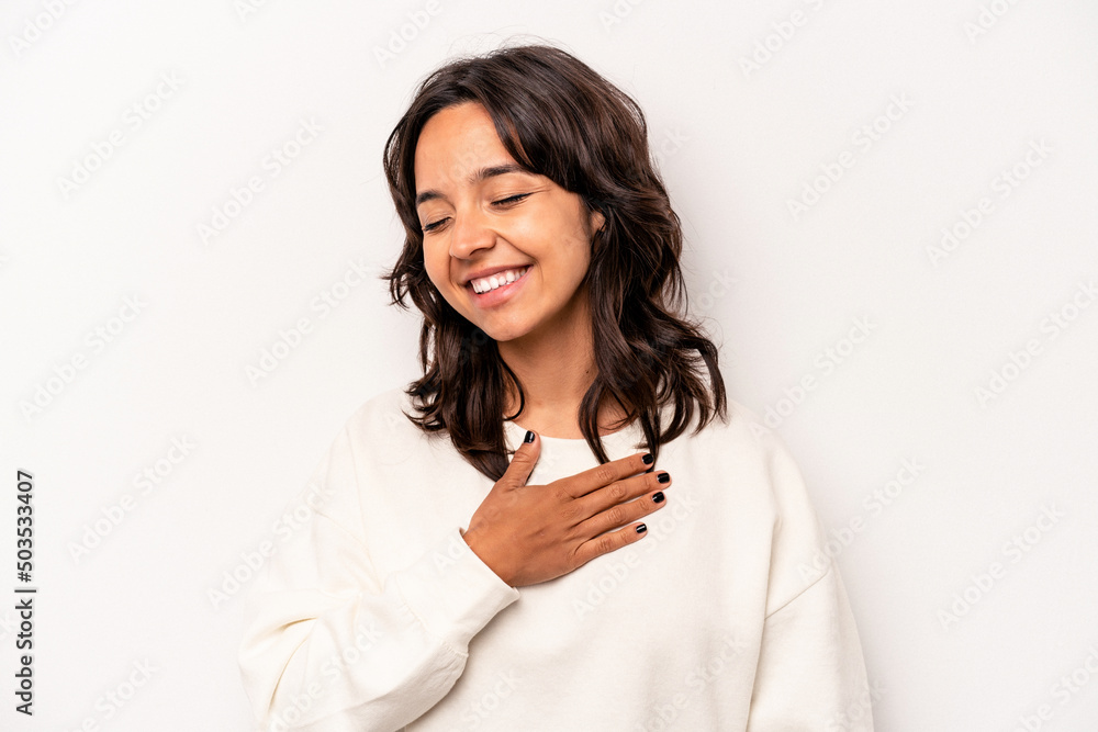 Young hispanic woman isolated on white background laughing keeping hands on heart, concept of happiness. Young hispanic woman isolated on white background laughing keeping hands on heart, concept of happiness.