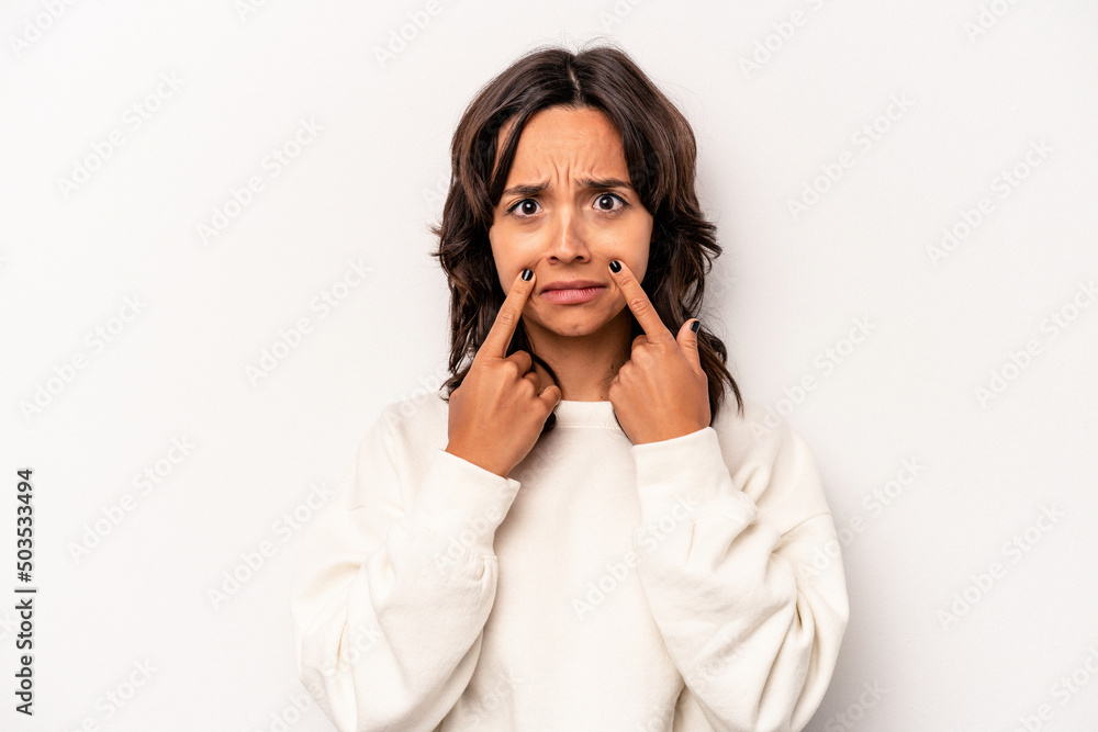Young hispanic woman isolated on white background crying, unhappy with something, agony and confusion concept. Young hispanic woman isolated on white background crying, unhappy with something, agony and confusion concept.