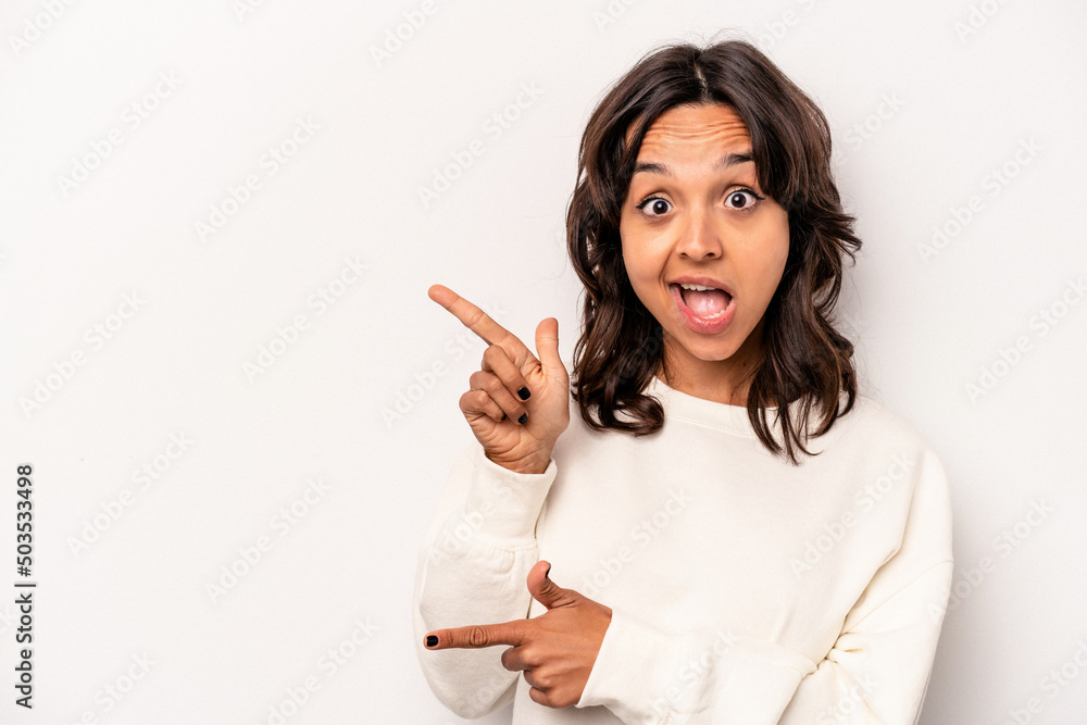 Young hispanic woman isolated on white background excited pointing with forefingers away. Young hispanic woman isolated on white background excited pointing with forefingers away.