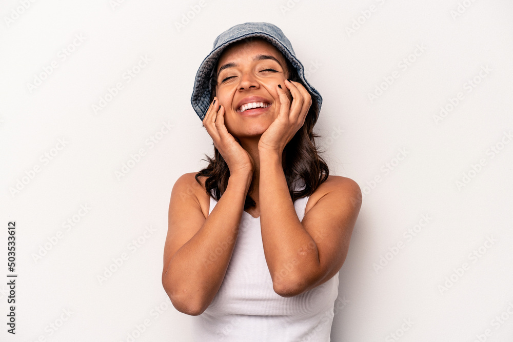 Young hispanic woman isolated on white background laughs joyfully keeping hands on head. Happiness concept. Young hispanic woman isolated on white background laughs joyfully keeping hands on head. Happiness concept.
