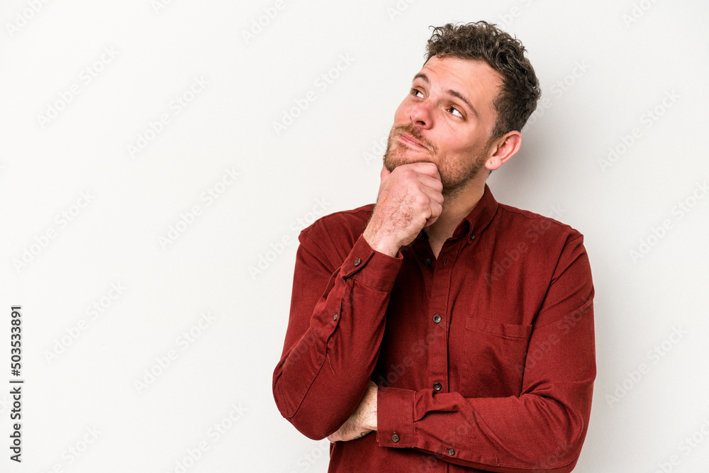 Young caucasian man isolated on white background looking sideways with doubtful and skeptical expression.