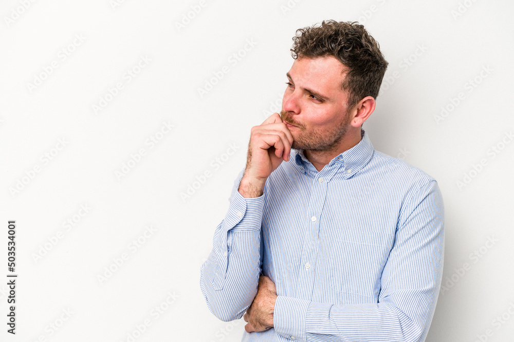 Young caucasian man isolated on white background relaxed thinking about something looking at a copy space. Young caucasian man isolated on white background relaxed thinking about something looking at a copy space.