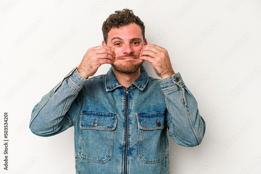 Young caucasian man isolated on white background doubting between two options. Young caucasian man isolated on white background doubting between two options.