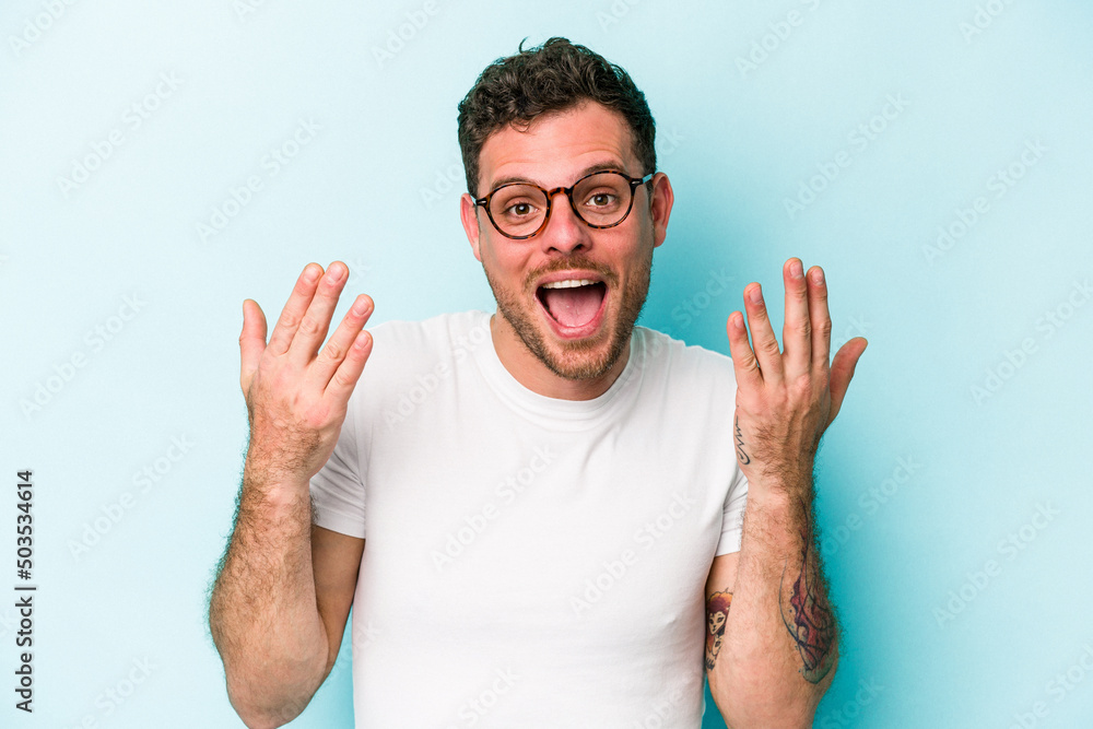 Young caucasian man isolated on blue background showing number ten with hands. Young caucasian man isolated on blue background showing number ten with hands.