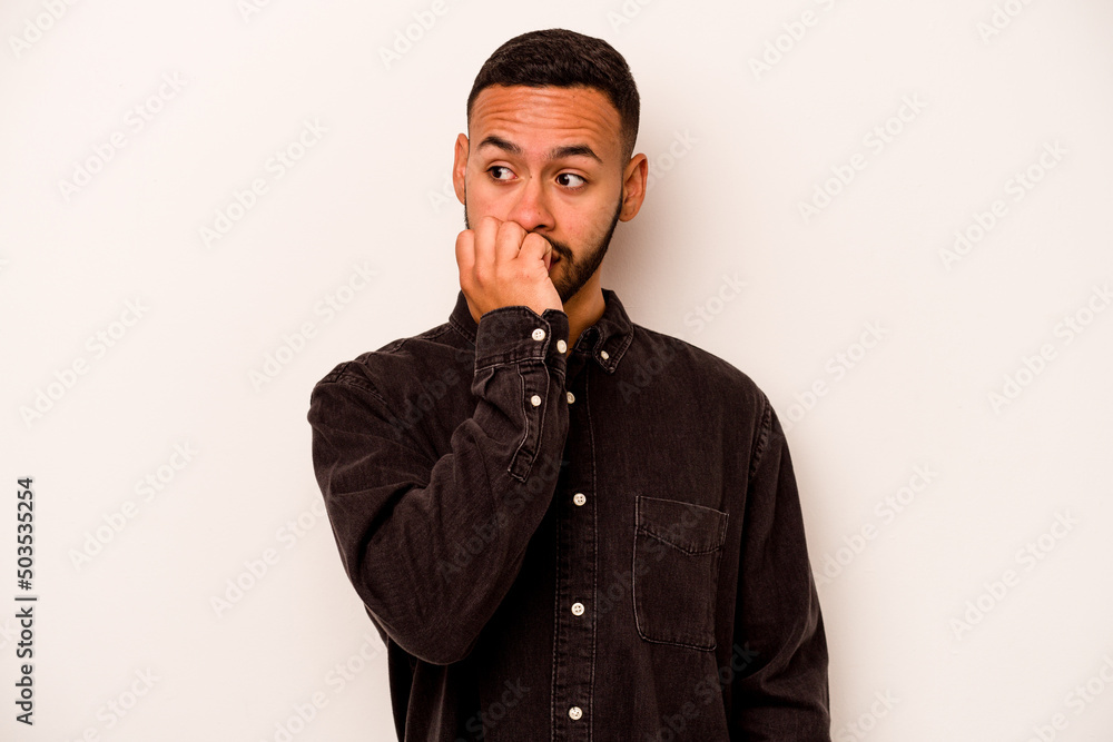 Young hispanic man isolated on white background biting fingernails, nervous and very anxious. Young hispanic man isolated on white background biting fingernails, nervous and very anxious.