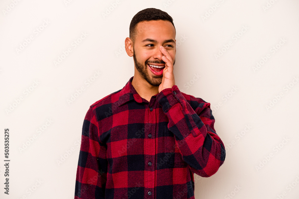 Young hispanic man isolated on white background shouting excited to front. Young hispanic man isolated on white background shouting excited to front.