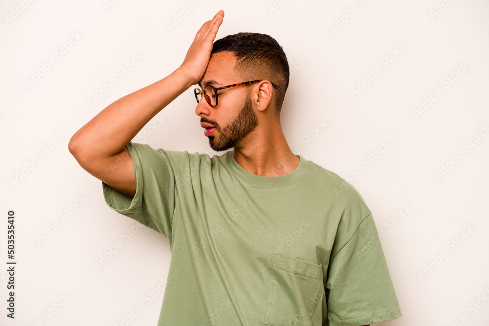 Young hispanic man isolated on white background forgetting something, slapping forehead with palm and closing eyes. Young hispanic man isolated on white background forgetting something, slapping forehead with palm and closing eyes.