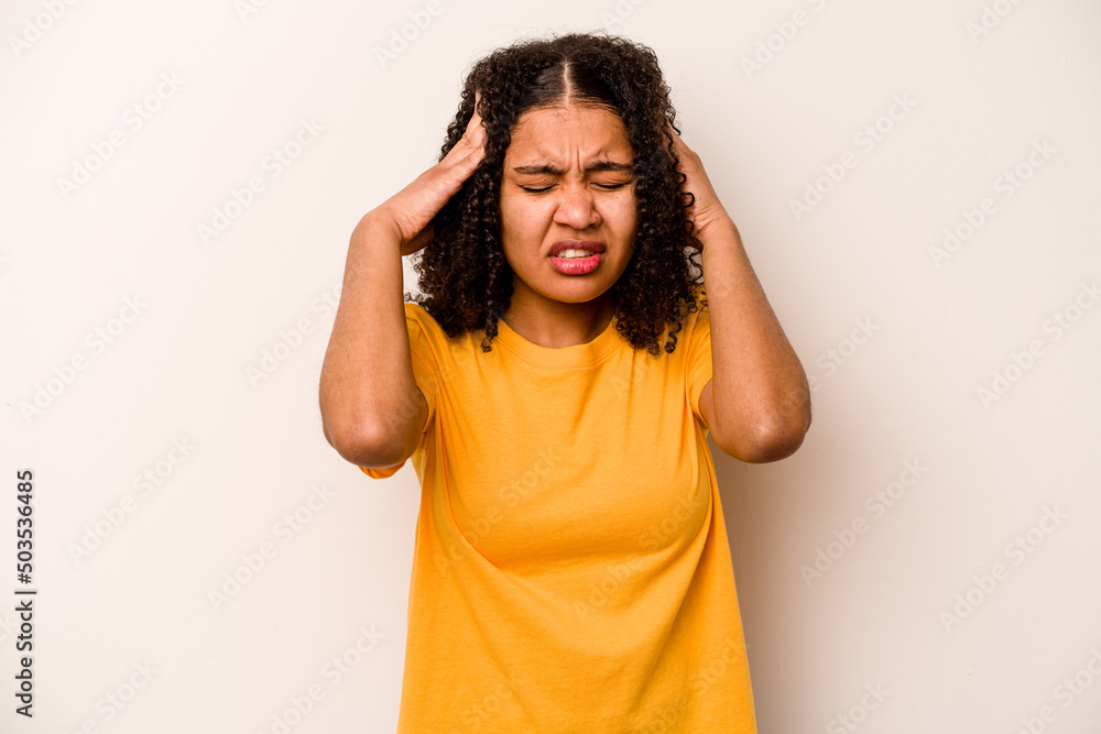 Young African American woman isolated on white background having a head ache, touching front of the face. Young African American woman isolated on white background having a head ache, touching front of the face.