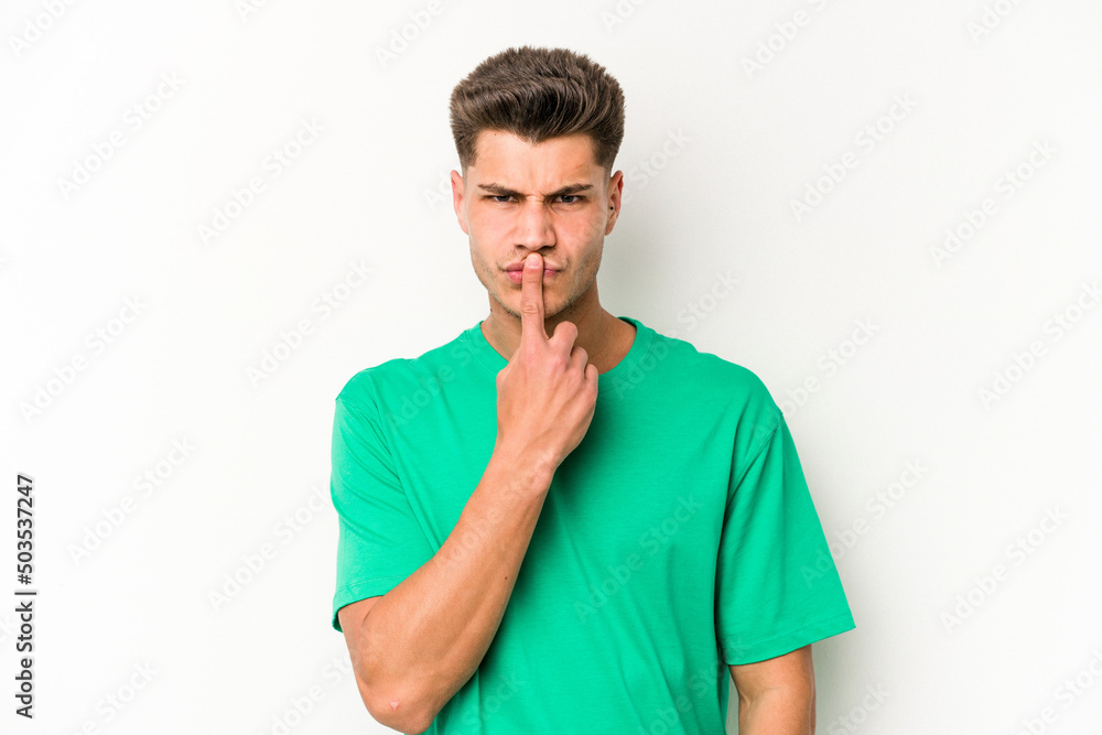 Young caucasian man isolated on white background thinking and looking up, being reflective, contemplating, having a fantasy.