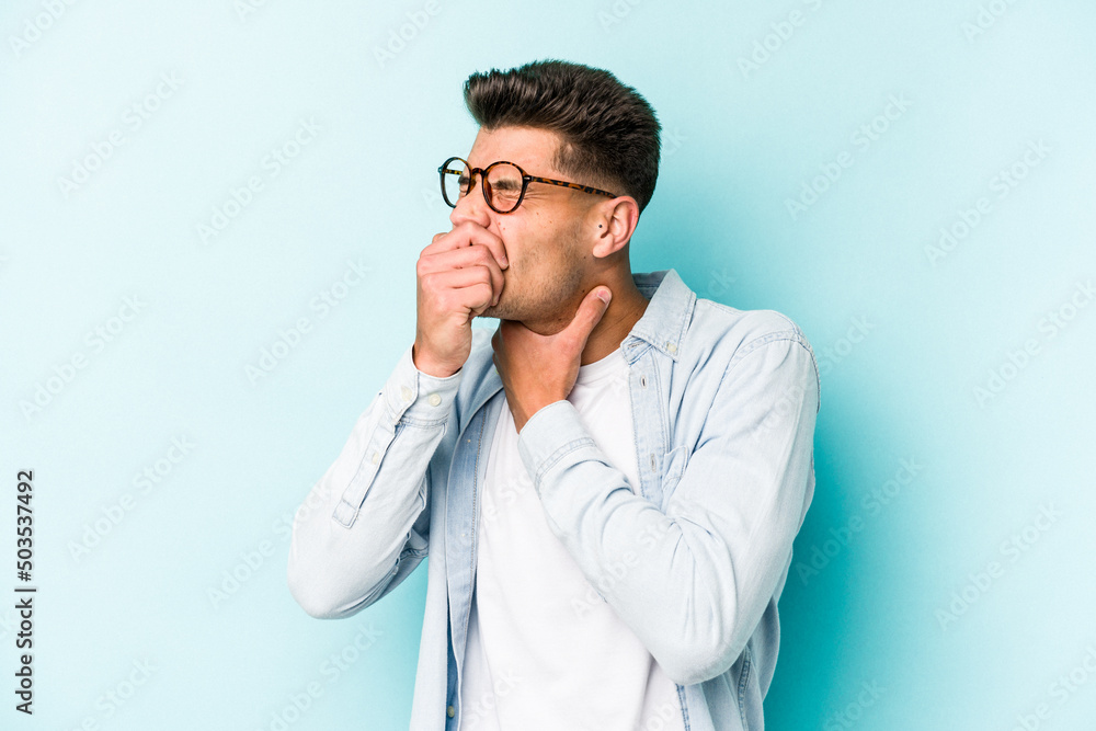 Young caucasian man isolated on blue background suffers pain in throat due a virus or infection. Young caucasian man isolated on blue background suffers pain in throat due a virus or infection.