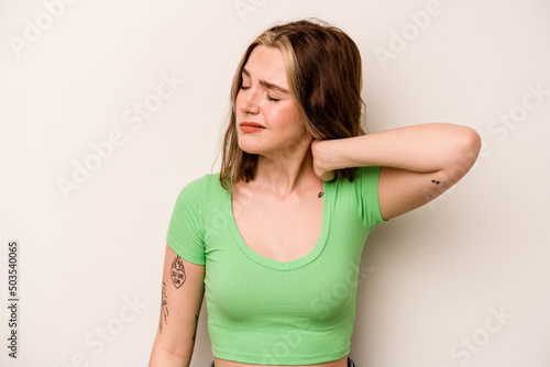 Young caucasian woman isolated on white background having a neck pain due to stress, massaging and touching it with hand.