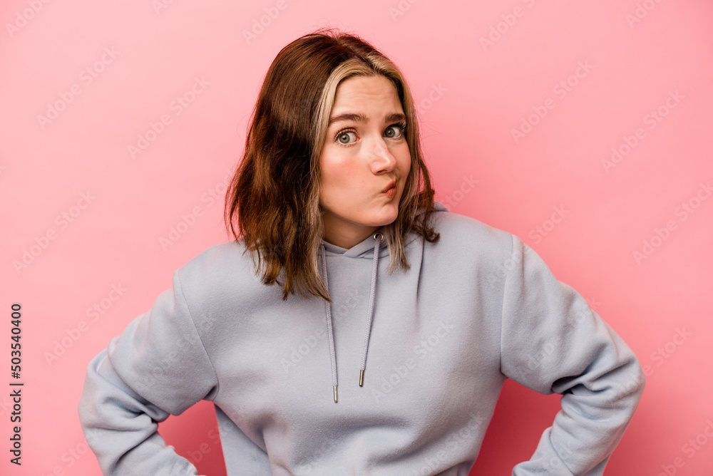 Young caucasian woman isolated on pink background confused, feels doubtful and unsure. Young caucasian woman isolated on pink background confused, feels doubtful and unsure.