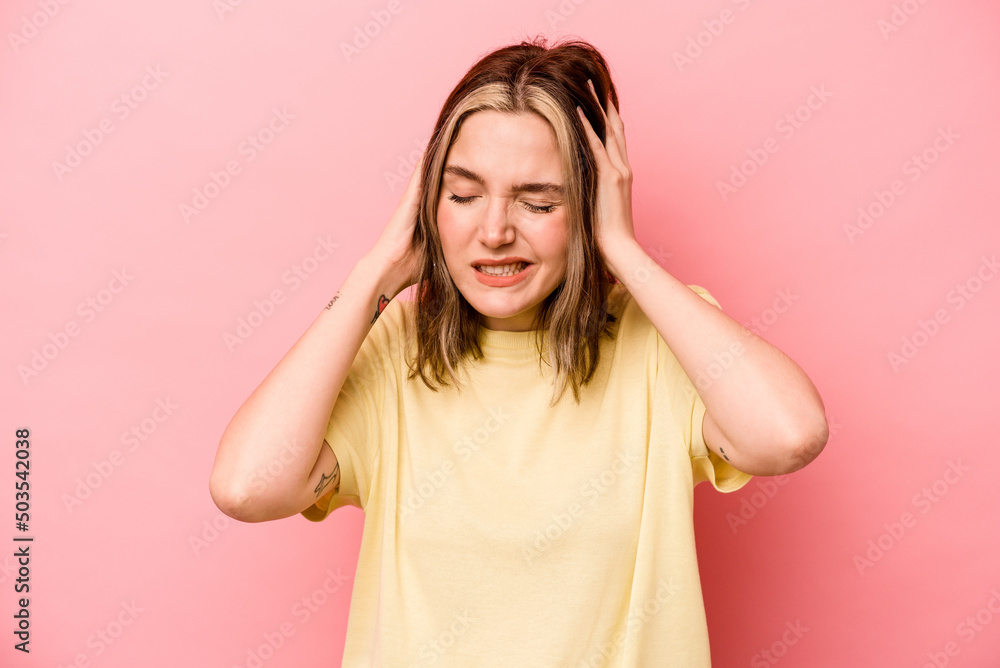 Young caucasian woman isolated on pink background covering ears with hands. Young caucasian woman isolated on pink background covering ears with hands.