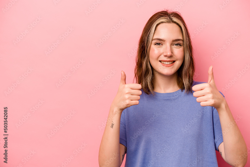 Young caucasian woman isolated on pink background smiling and raising thumb up Young caucasian woman isolated on pink background smiling and raising thumb up