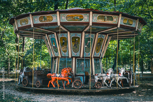 Abandoned horse carousel in a park.