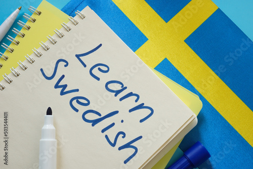 Learn Swedish. Open notebook, pen and flag. photo