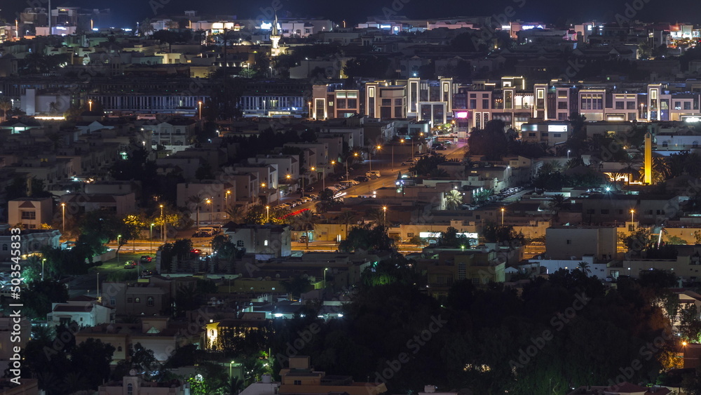 Aerial view of apartment houses and villas in Dubai city night timelapse, United Arab Emirates