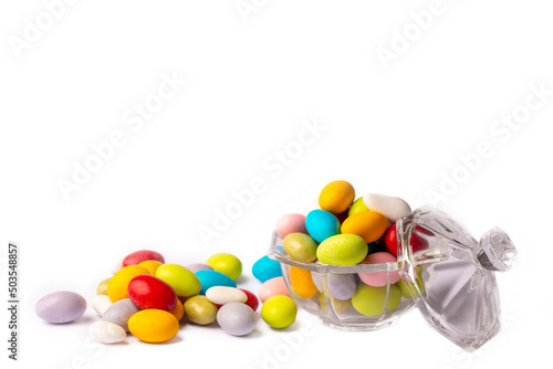 Colorful almond candies in the stylish,crystal candy bowl on white with copy space.The Sugar Feast concept. (Turkish name; Ramadan - Ramazan bayrami, Seker bayrami)