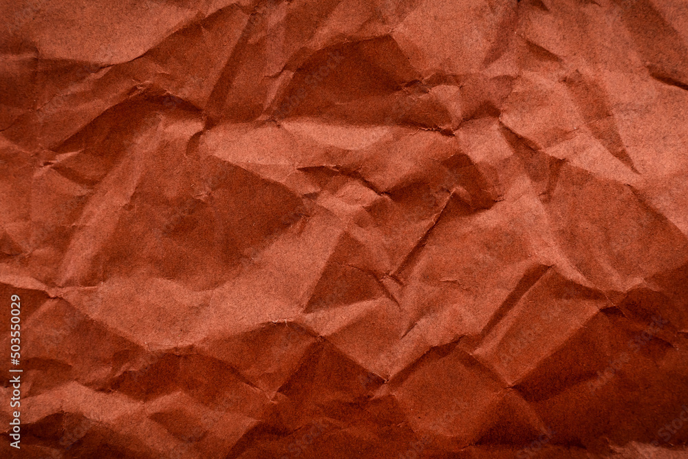 Background from crumpled brown color paper. Paper with scuffs and waves Background from crumpled brown color paper. Paper with scuffs and waves