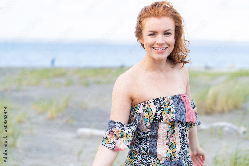 Pretty woman with red hair and freckles at the ocean beach Pretty woman with red hair and freckles at the ocean beach