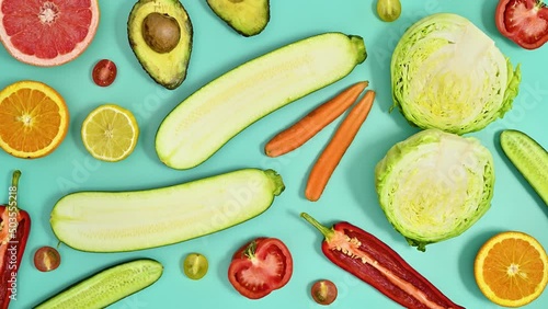 Wallpaper Mural Creative moving pattern with fruits and vegetables on cyan background. Healthy food concept. Stop motion flat lay Torontodigital.ca