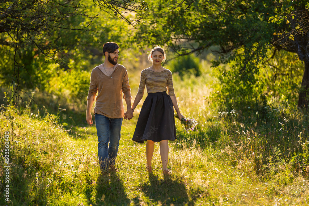 Fototapeta premium happy young couple walking in nature