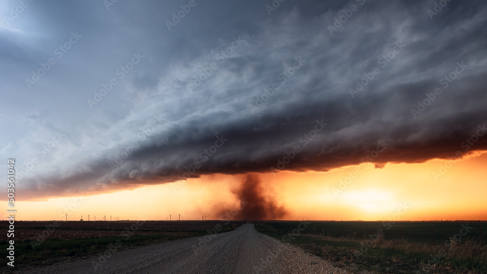 Tornado and dramatic storm clouds at sunset