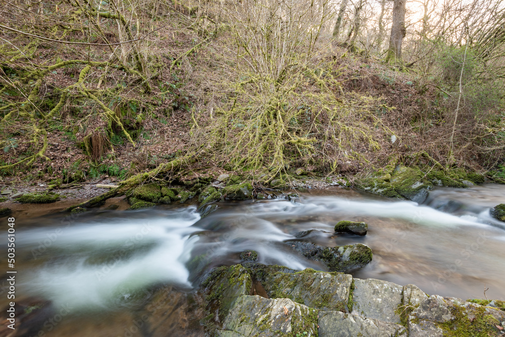 Long exposure of a waterfall on the river Horner in Horner woods in Somerset Long exposure of a waterfall on the river Horner in Horner woods in Somerset