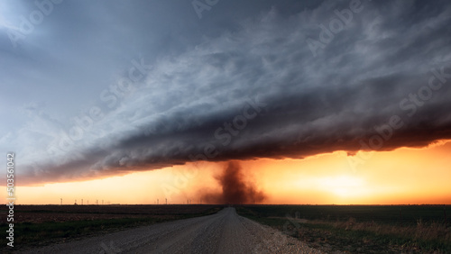 Fototapeta Naklejka Na Ścianę i Meble -  Tornado and dramatic storm clouds at sunset
