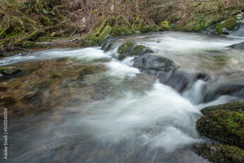 Fototapeta Naklejka Na Ścianę i Meble -  Long exposure of a waterfall on the river Horner in Horner woods in Somerset