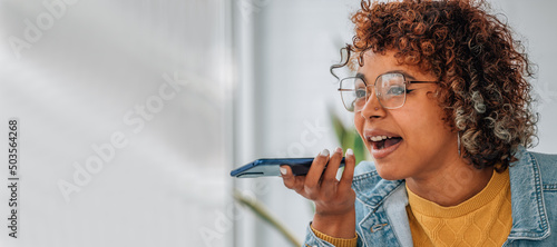 Photo girl with mobile phone sending or recording voice message