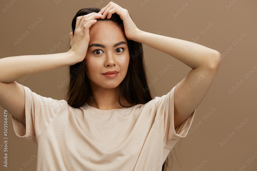 Fototapeta premium young woman t-shirt posing modern styles cosmetics beige background