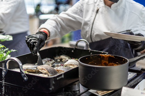 фотографія Waiter serving the fish on the plate