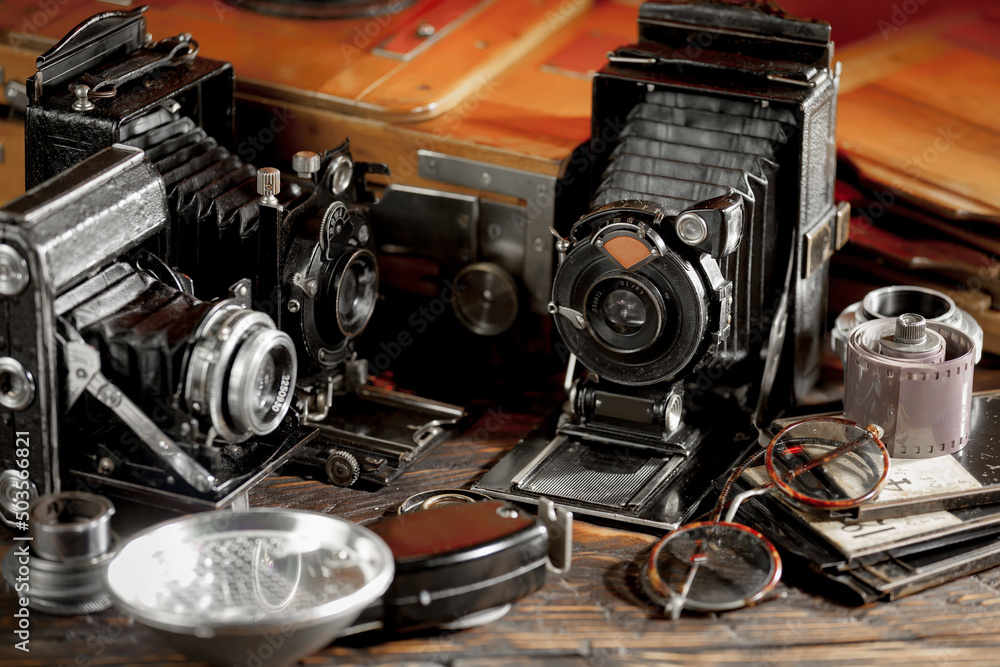 An old camera in a composition on an old background, on a table