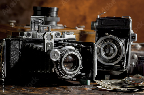 Old vintage cameras on an old background.