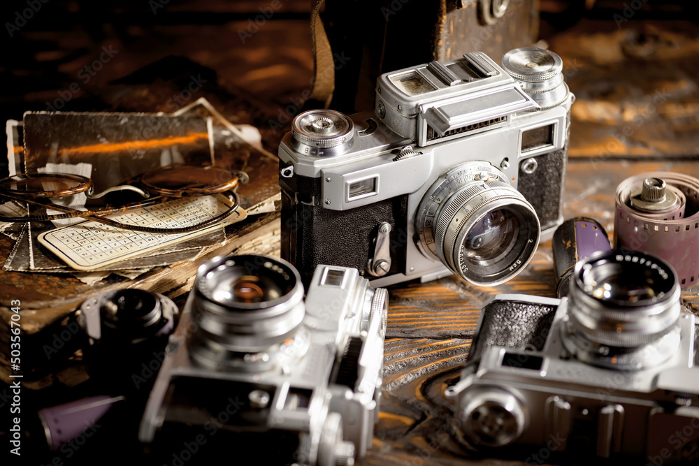 Old vintage cameras on an old background.