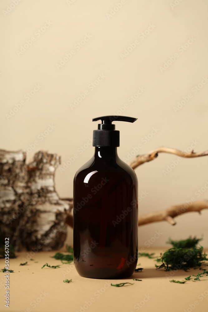 Soap or shampoo pump bottle with bark, tree branch, green moss. SPA natural cosmetic concept.