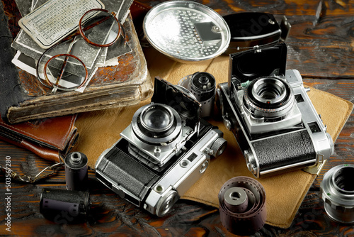 Old vintage cameras on an old background.