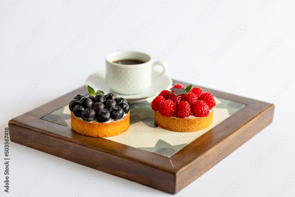Mix cakes with fresh berries on white background Mix cakes with fresh berries on white background